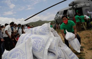 Nepalese volunteers unload relief material brought in an Indian air force helicopter for victims of Saturdayís earthquake at Trishuli Bazar in Nepal, Monday, April 27, 2015. The death toll from Nepal's earthquake is expected to rise depended largely on the condition of vulnerable mountain villages that rescue workers were still struggling to reach two days after the disaster.  (AP Photo/Altaf Qadri)